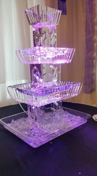 A stunning ice sculpture being used for a shrimp cocktail display.