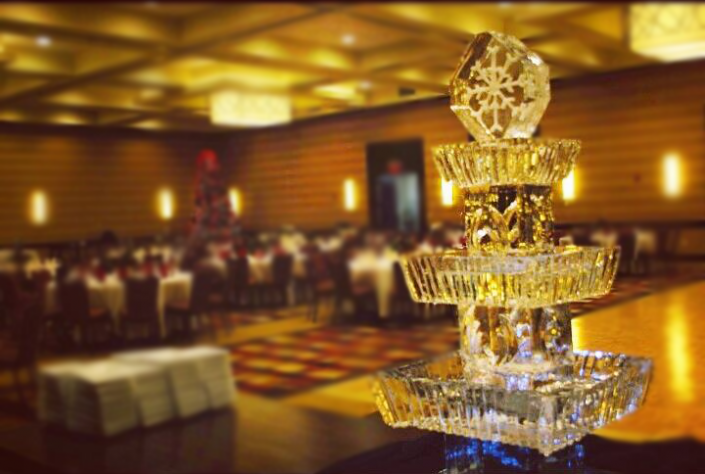 Food display ice sculpture with tiers and a topper.